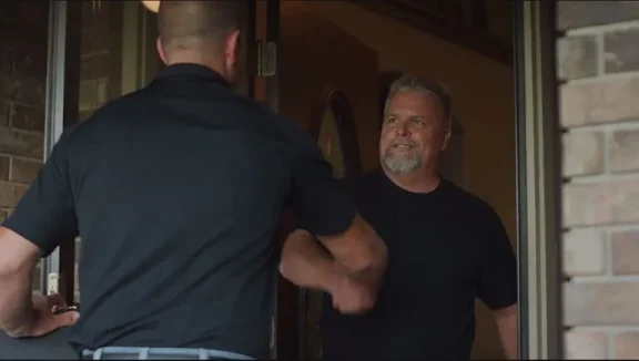 A Mid Kansas rep shakes hands with a home owner.